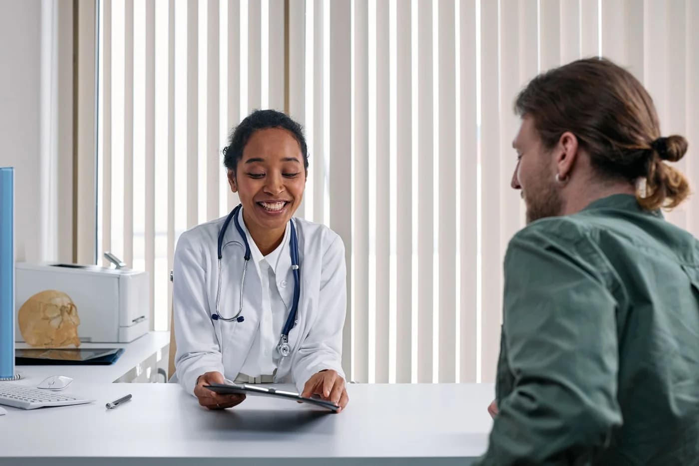 A doctor and patient discussing care together in a clinic